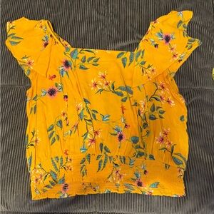 Ana yellow floral blouse short sleeve top with a square neckline.